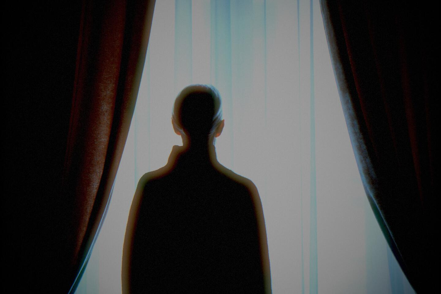 The same photo processed by the Medianoche machine: the subject stays warm under the flash while the room falls away into blue.