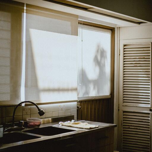A kitchen window in daylight, unprocessed: the photo the 2 machines in this family start from.